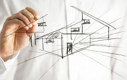 Architect drawing architectural house plan on virtual screen.